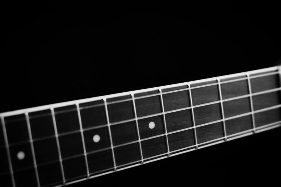 ukulele strings on black background