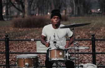 A man playing drums in the park