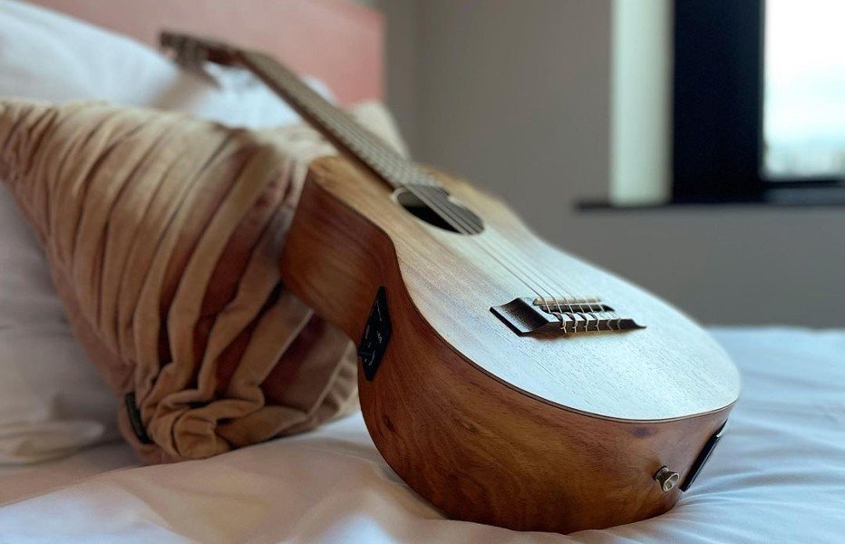 wooden Guitalele lies on the table